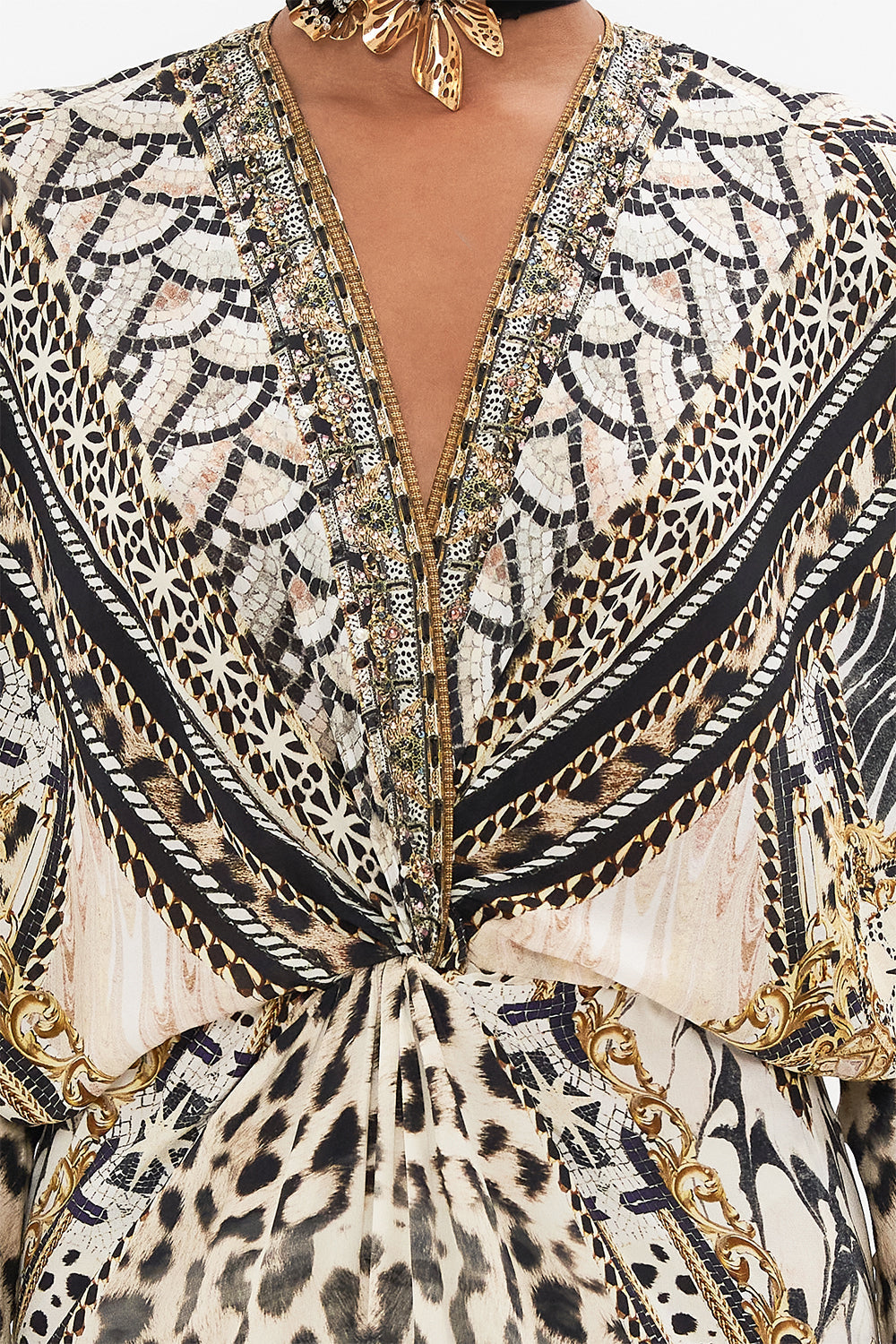 Detail view of model wearing CAMILLA silk batwing dress in Mosiac Muse print