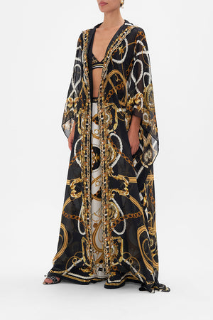 Side view of model wearing CAMILLA silk robe in Coast To Coast print