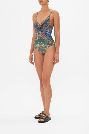 Side view of model wearing CAMILLA one piece swimsuit in Fan Dance print