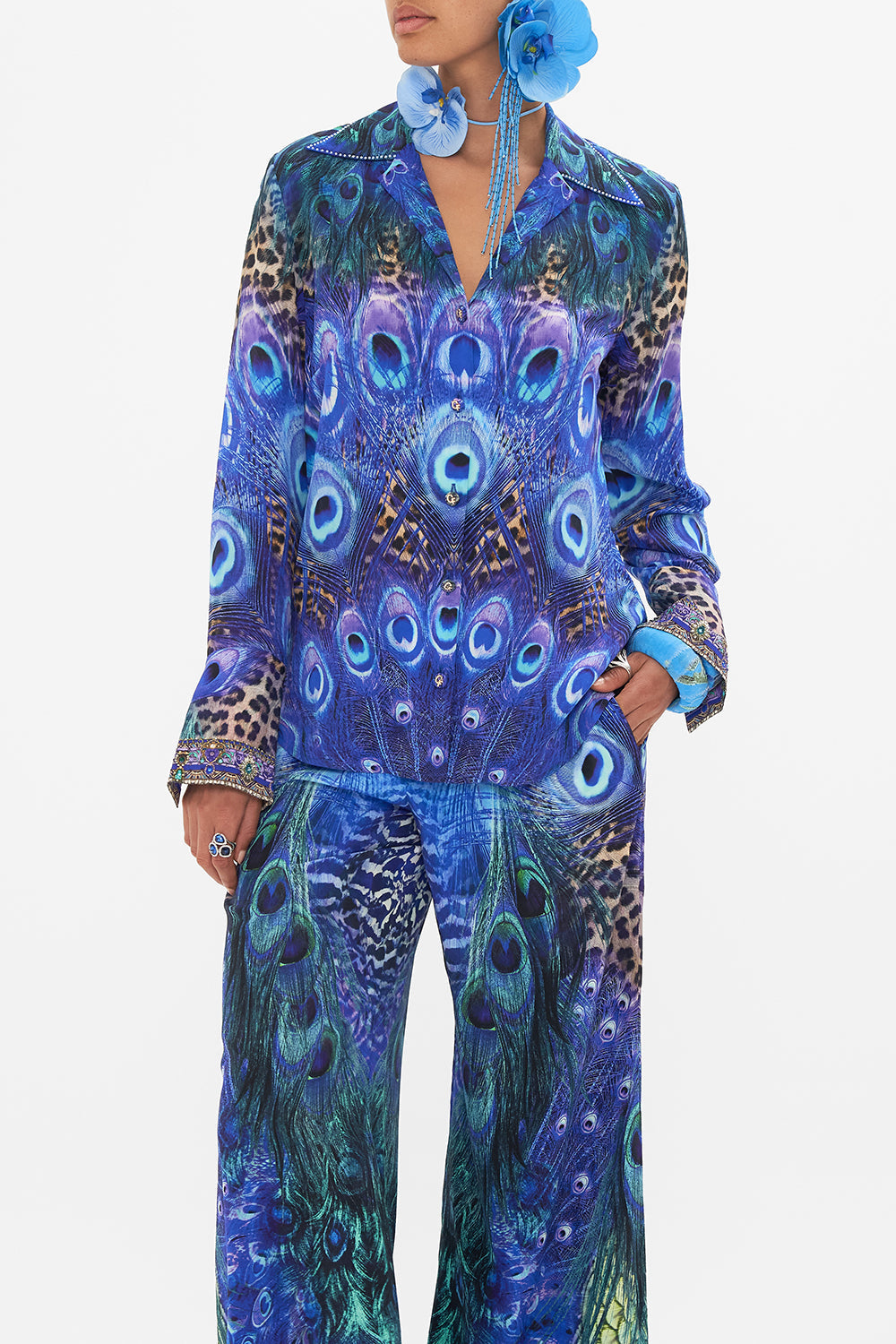 Crop view of model wearing CAMILLA silk shirt in Peacock Rock print