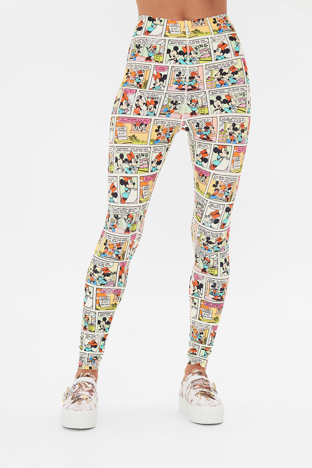 Crop view of model wearing CAMILLA x Disney leggings in A Trip Down Comic Strip print