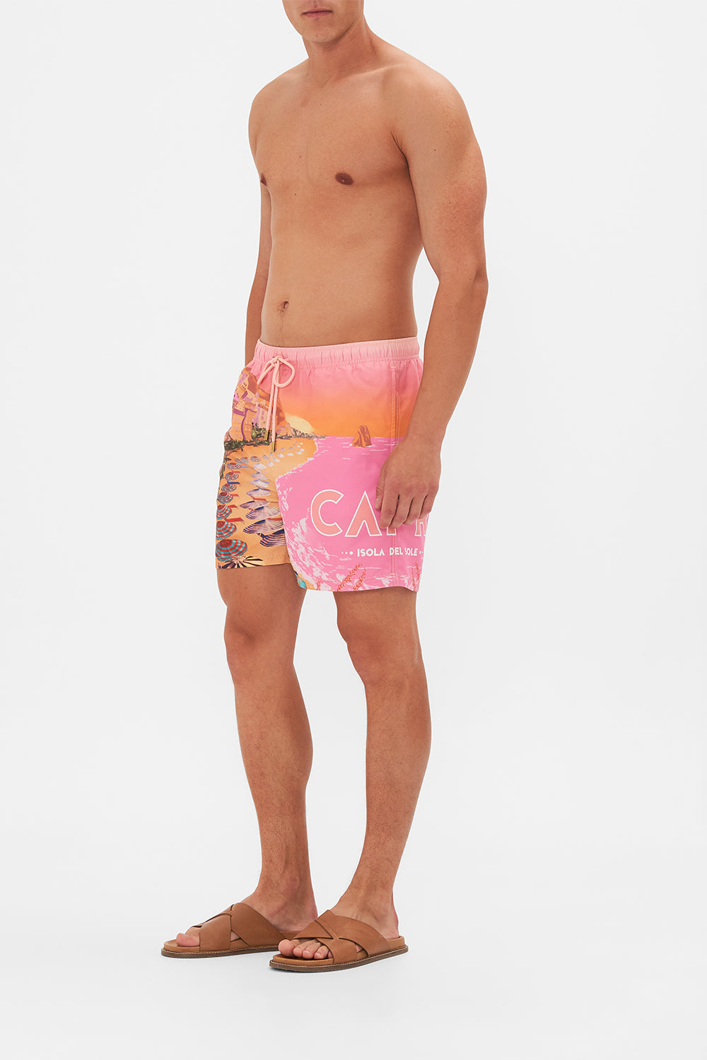 Side view of model wearing Hotel Franks By CAMILLA mens boardshorts in Capri Me print