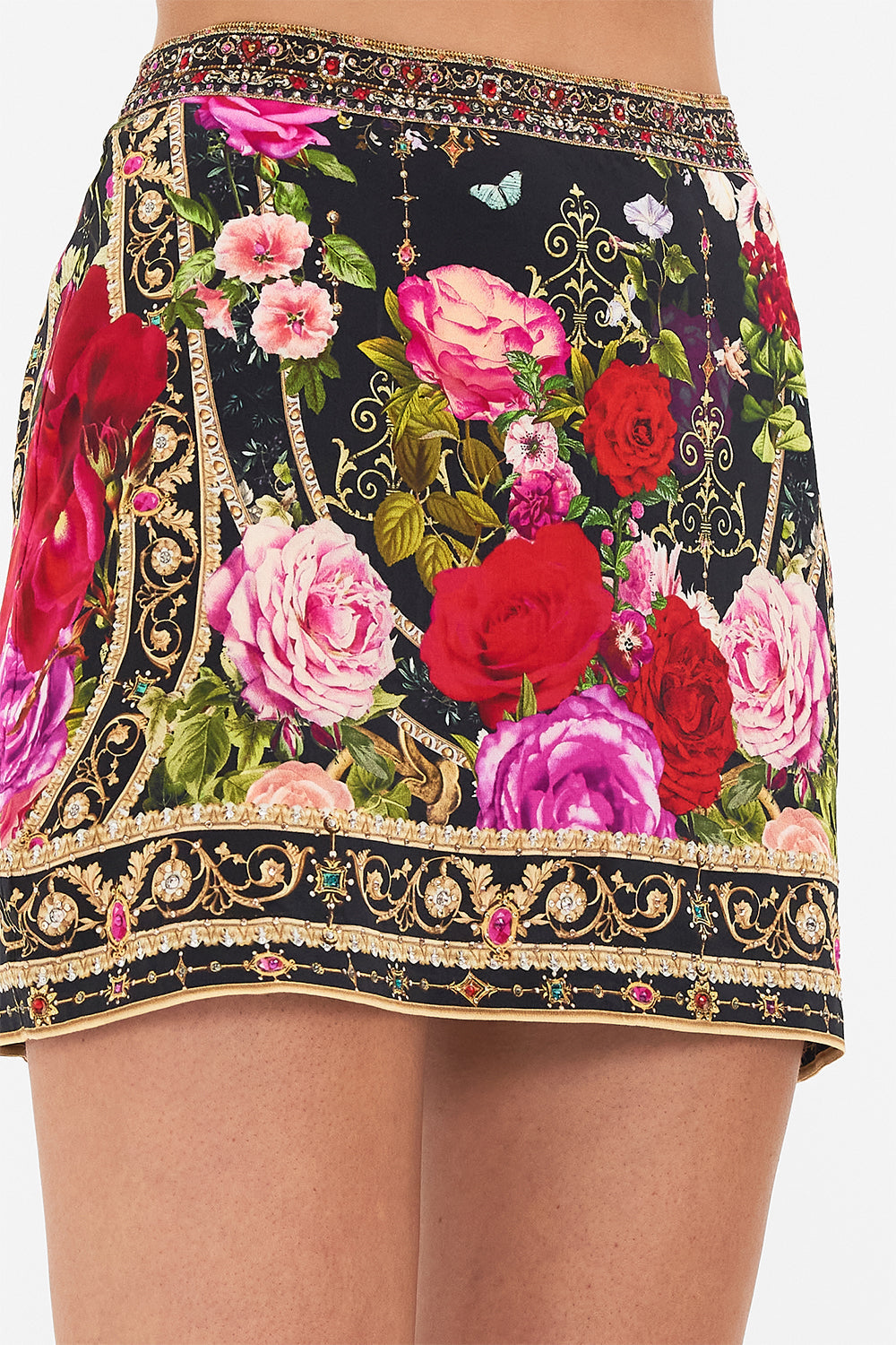 Detail view of model wearing CAMILLA floral mini skirt in Reservation For Love print