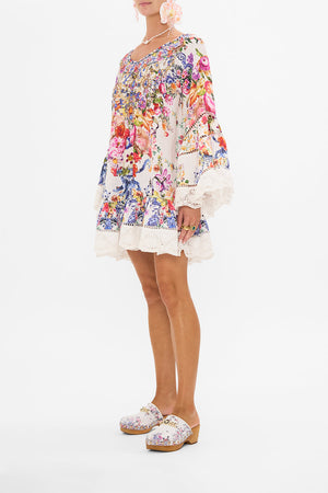 Side view of model wearing CAMILLA frill dress in Dutch Is Life print