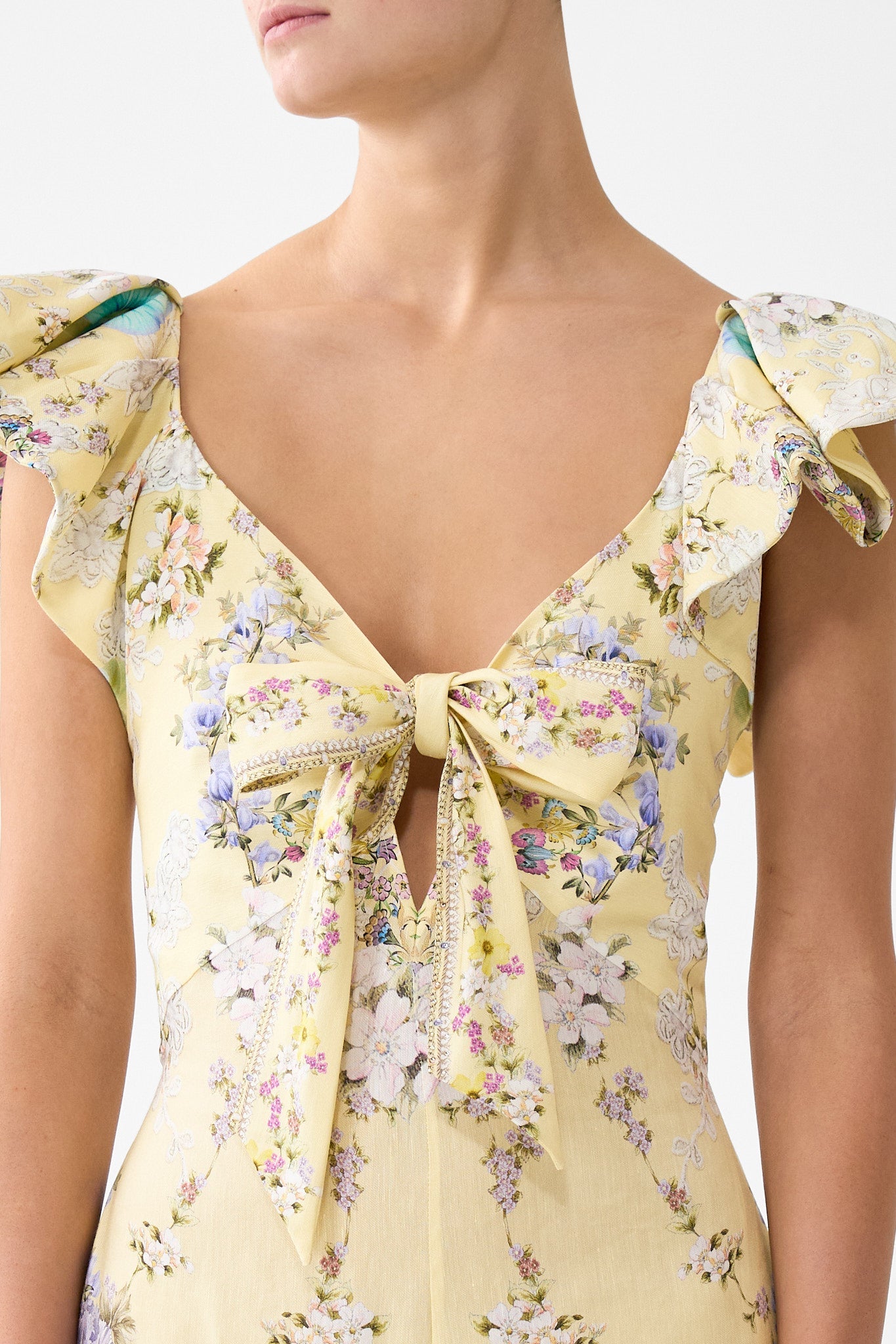 The CAMILLA TIE FRONT FRILL SLEEVE JUMPSUIT DARLING BUDS in our  print.