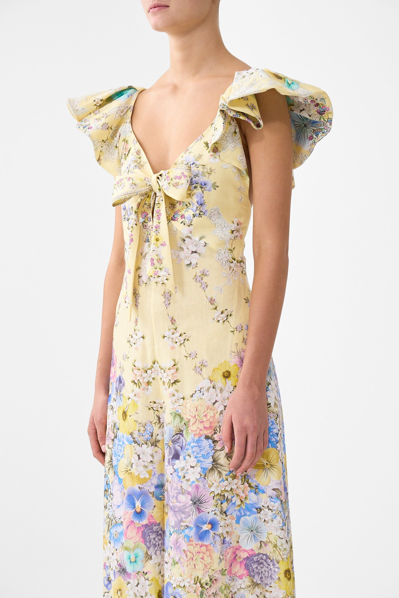 The CAMILLA TIE FRONT FRILL SLEEVE JUMPSUIT DARLING BUDS in our  print.