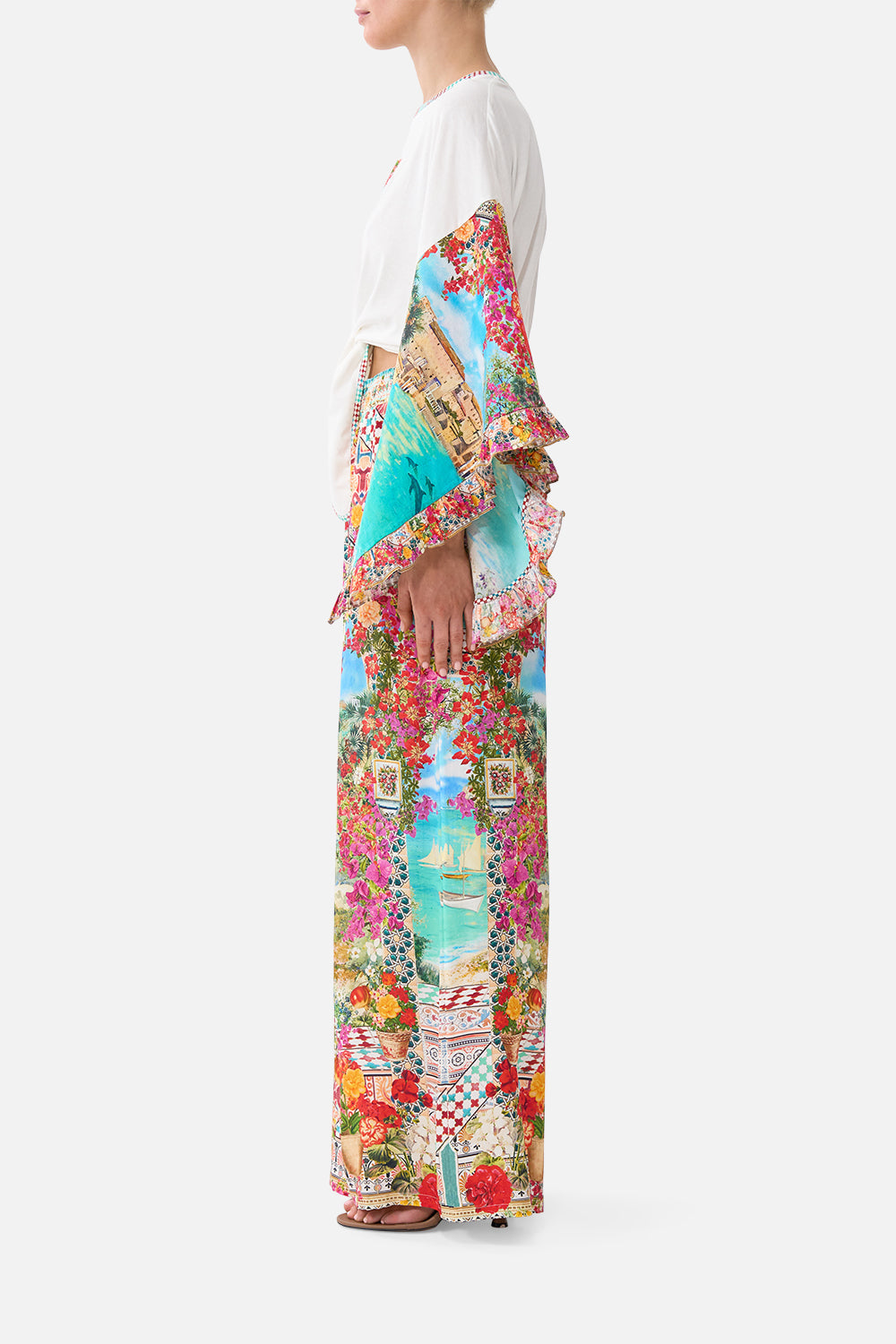The CAMILLA tie front ruffle sleeve t shirt in our print Meet Me in Mallorca. Side model view.