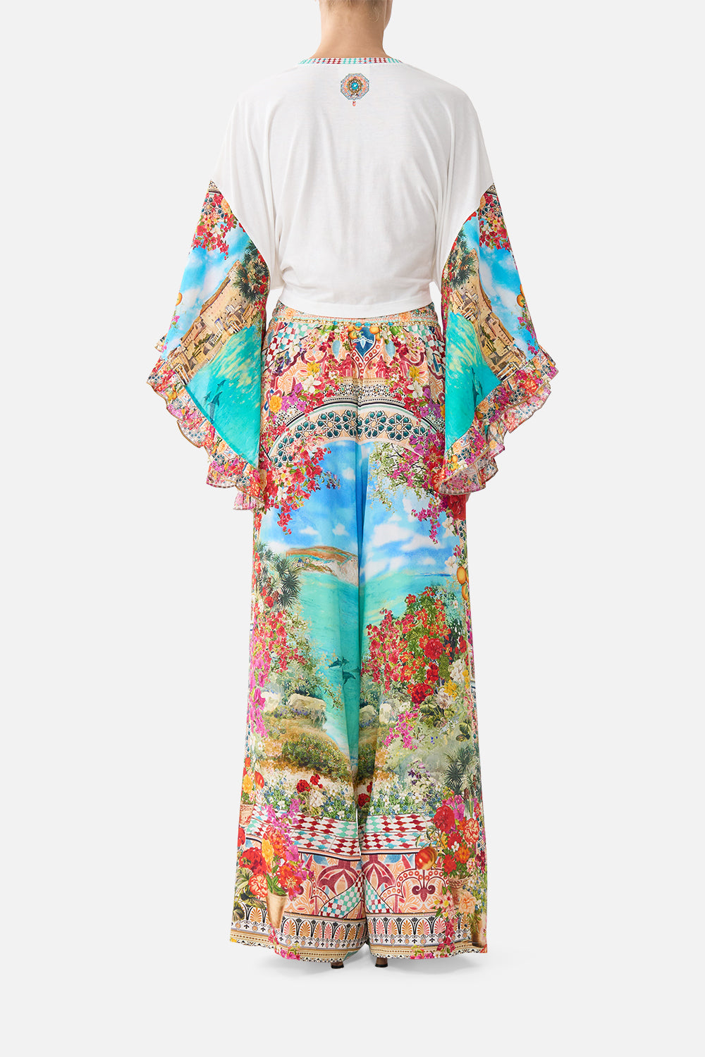 The CAMILLA tie front ruffle sleeve t shirt in our print Meet Me in Mallorca. Back model view.
