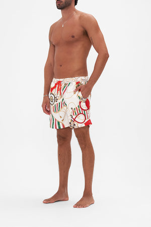 Side view of model wearing Hotel franks By CAMILLA mens boardshort in Saluti Summertime print